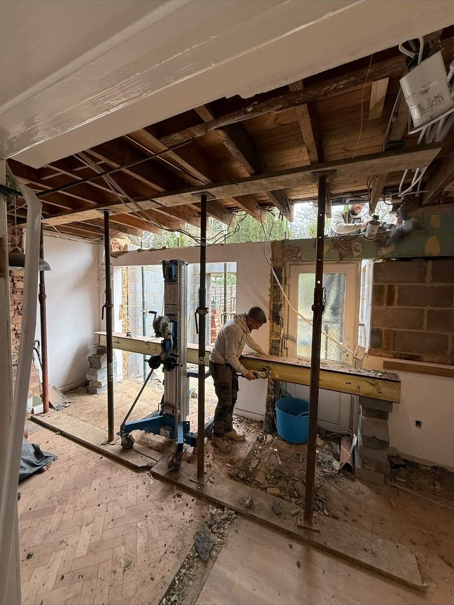 The RS team installing a structural steel beam during a knock-through